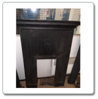  black cast iron fire surround (with cherub insert). Size : 51 inches high 30 inches wide shelf on top 39 inches long x 7 inches wide.